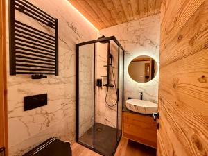 a bathroom with a shower and a sink at Il bosco di Fiemme in Predazzo +22 photos
