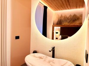 a bathroom with a sink and a mirror at Il bosco di Fiemme in Predazzo