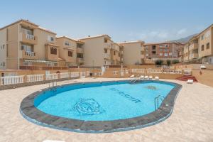 a swimming pool in front of some apartment buildings at Apartamento Afirama 1 in Araya