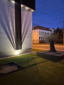 a building with a tree on the side of it at Apartmán Maťko in Levice