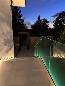 a building with a glass fence and a hallway at Apartmán Maťko in Levice