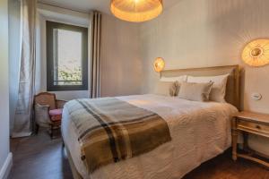 a bedroom with a bed and a chair and a window at Torra di l alba in Viggianello +84 photos