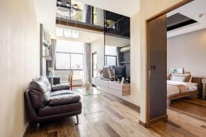 a bedroom with a bed and a couch and a chair at Moda Condo Nimman 608 - Super Deluxe Mountain View next to MAYA in Chiang Mai +51 photos