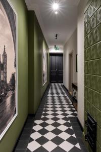 a hallway with a black and white checkered floor at OLD TOWN Charm & Chic by Downtown Apartments in Kraków
