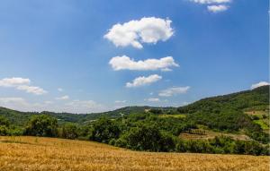 a grassy hill with a blue sky and clouds at 2 Bedroom Stunning Home In Casacastalda in Casa Castalda +22 photos
