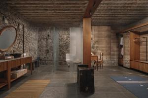 a bathroom with a mirror and a sink and a counter at Tipai Wildlife Luxuries in Pahāpal
