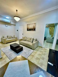 a living room with two couches and a table at Karnak Flats in Luxor
