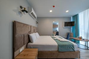 a bedroom with a bed and a table and a tv at Casa Nova Hotel in Istanbul