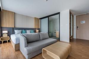a living room with a bed and a couch at Wyndham Gardens Forrest View 1216 Studio in Nai Thon Beach