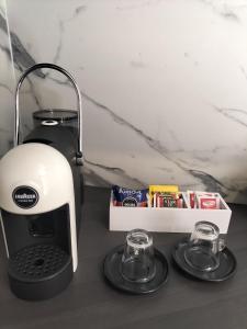 a coffee maker and two glasses on a counter at L'Alloggio del Fattore in LʼAquila +6 photos
