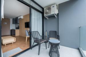 a room with two chairs and a table at Wyndham Gardens Forrest View 1216 Studio in Nai Thon Beach