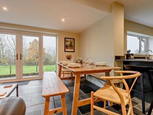 a dining room with a wooden table and chairs at 3 Bed in Threlkeld 93589 in Threlkeld