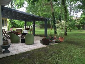 a patio with potted plants in a yard at La maison de caroline in Marcheprime