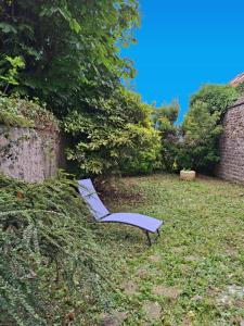 a couple of lounge chairs sitting in the grass at Cosy avec spa et sauna et jardin in Boulogne-sur-Mer +22 photos