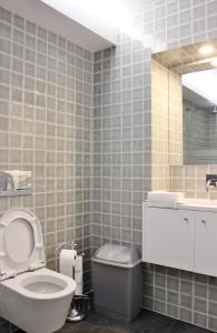 a bathroom with a toilet and a sink and a mirror at Aldeia do Priolo in Nordeste +37 photos