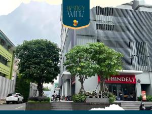 a sign for a hong kongury wk building in a city at Honey Wink - 5 Min Walk to Walking Street in Ho Chi Minh City