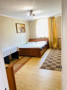 a small bedroom with a bed and a window at Сдам две комнаты возле моря in Odesa +4 photos