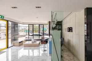 a lobby of a building with a table and chairs at Moda Condo Nimman 608 - Super Deluxe Mountain View next to MAYA in Chiang Mai