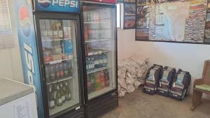 a store with two refrigerators in a room at Little Sossus Campsite in Sesriem