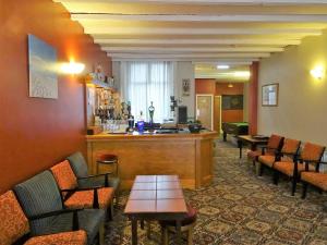 a waiting room with chairs and a bar in a hotel at The Belvedere in Blackpool