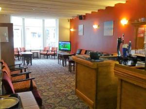 a bar in a restaurant with tables and chairs at The Belvedere in Blackpool