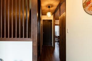 a hallway of a house with wood paneling at 和氣会々南長崎 Wakiaiai Minaminagasaki in Tokyo