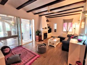 a living room with a couch and a table at Villa Tossalet VYB in El Tosalet