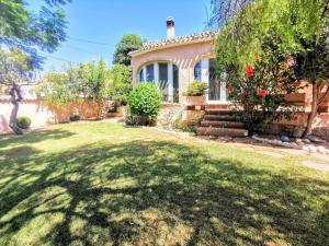 a house with a lawn in front of it at Villa Tossalet VYB in El Tosalet