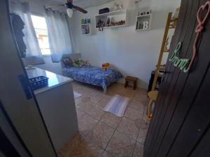 a kitchen and a living room with a couch at Pousada belas ilhas in Balneario Barra do Sul