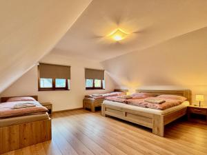 a bedroom with two beds and a ceiling at Terchovský dvor - Ubytovanie & wellness in Terchová