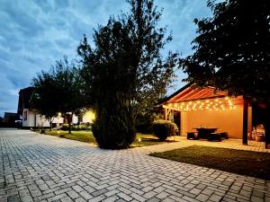 a pavilion with lights on the side of a house at Terchovský dvor - Ubytovanie & wellness in Terchová