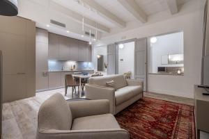 a living room with a couch and a table at Old Theatre Suites - Elba in Valletta