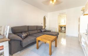 a living room with a couch and a table at Gorgeous Home In Orihuela in Villamartin