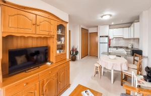 a kitchen with a large entertainment center with a flat screen tv at Beautiful Apartment In Canet De Berenguer in Canet de Berenguer