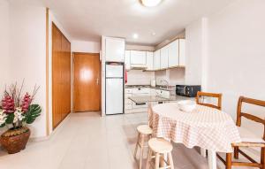 a kitchen and dining room with a table and chairs at Beautiful Apartment In Canet De Berenguer in Canet de Berenguer