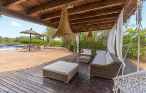 a porch with a swing and chairs and a pool at Finca Tortuga De Son Cifre in Manacor