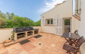 a patio with a grill and a table and chairs at Finca Tortuga De Son Cifre in Manacor