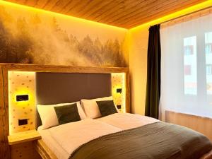 a bedroom with a large bed in a room at Il bosco di Fiemme in Predazzo