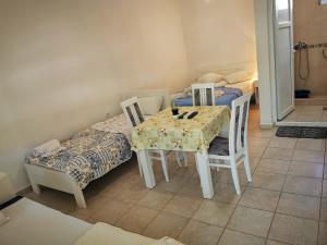 a dining room table and chairs with a table and a table and chairsuggest at Guest House Levant in Čanj