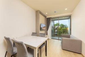 Laguna PhuketにあるModern 1-BR at The Ozone Phuket BangTao Beach by TropicLookの白いテーブルと椅子のあるダイニングルーム