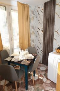 a dining room with a table and chairs at Good Mood Apartments & Parking 2 in Plovdiv