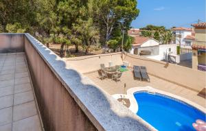 a view of a swimming pool on a balcony at 3 Bedroom Stunning Home In Miami Platja in Miami Platja +18 photos
