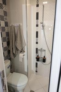 a bathroom with a toilet and a shower at Good Mood Apartments & Parking 2 in Plovdiv +32 photos