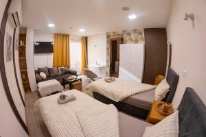 a living room with two beds and a couch at Good Mood Apartments & Parking 2 in Plovdiv