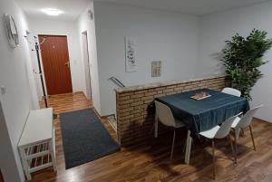 a dining room with a table and chairs and a brick wall at Werkswohnnung Heide Süderholm in Heide
