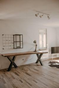 a table in an empty room with a lamp on it at Stylish apartment mit Bachblick in Vallendar +19 photos