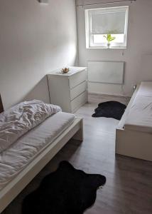 a bedroom with a bed and a dresser and a window at Handwerker Wohnung im Landhaus in Ramhusen +1 photo