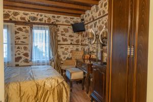 a bedroom with a bed and a desk and a television at Harmony Butik Otel in Alanya