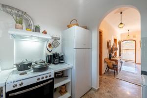 a kitchen with a stove and a white refrigerator at Nana's House Holidays Greece in Dragotiná +23 photos
