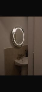 a bathroom with a sink and a mirror on the wall at Vikendica Trebižat river in Čapljina